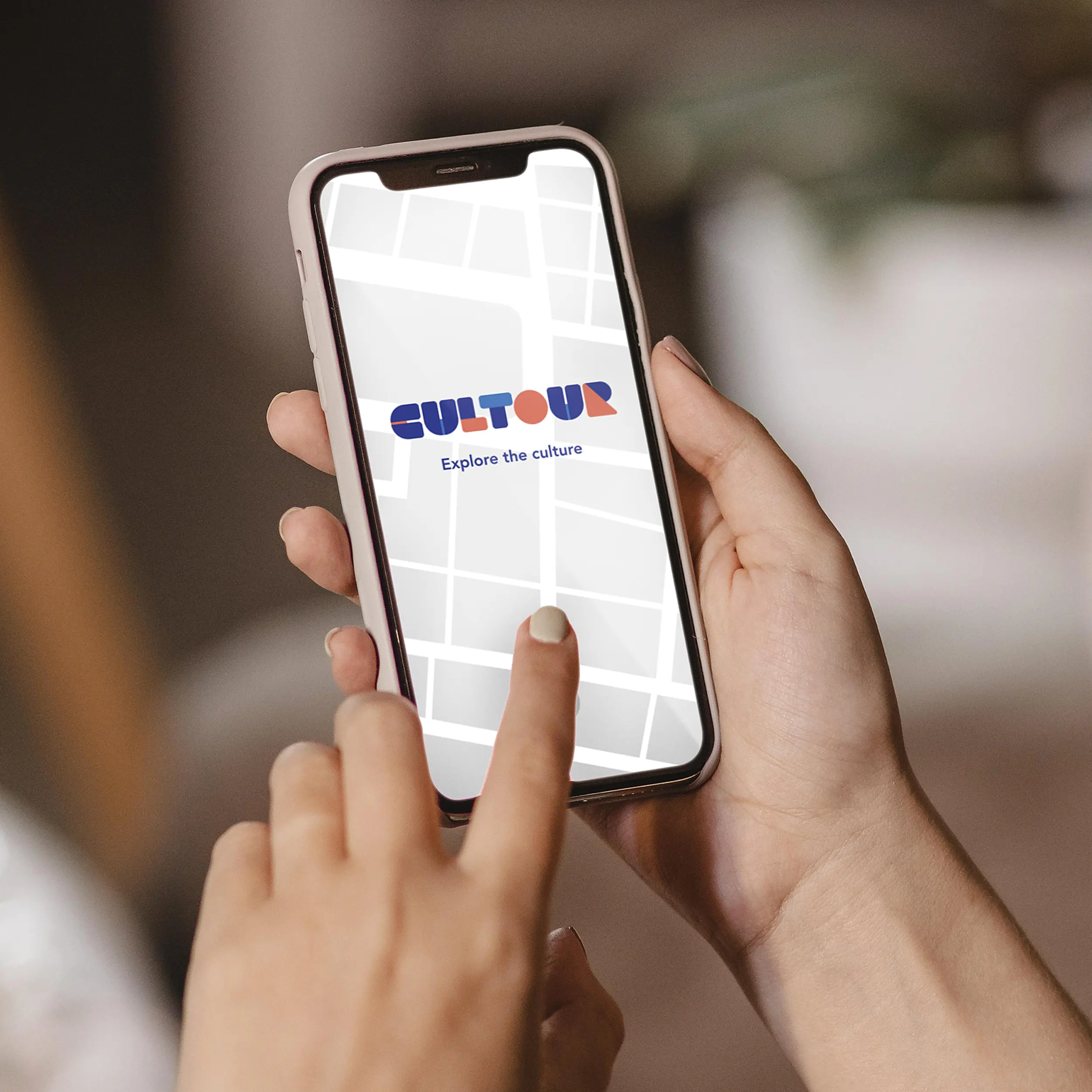 A person holding a cellphone interacting with the Cultour app